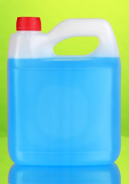 Blue liquid for car in canister on green background — Stock Photo, Image