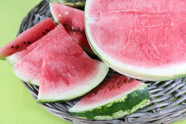 Ripe watermelons on wicker tray on wooden table — Stock Photo, Image