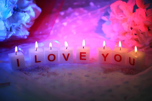 Candles with printed sign I LOVE YOU,on color fabric background — Stock Photo, Image