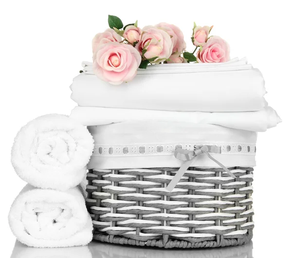 Bedding sheets in wicker basket isolated on white — Stock Photo, Image