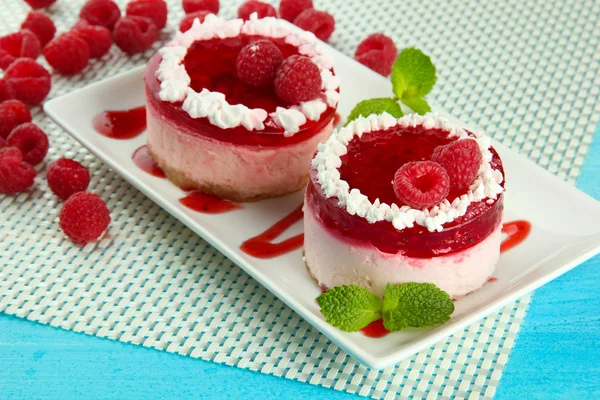 Delicious berry cakes on plate on table close-up — Stock Photo, Image