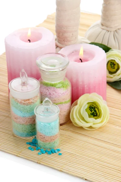 Aromatic salts in glass bottles and spa treatment, on bamboo mat, isolated on white — Stock Photo, Image