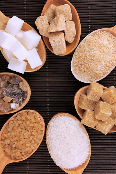 Different types of sugar in spoons on table close-up — Stock Photo, Image