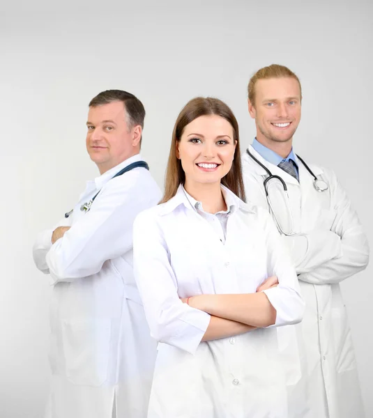 Medical workers on grey background — Stock Photo, Image