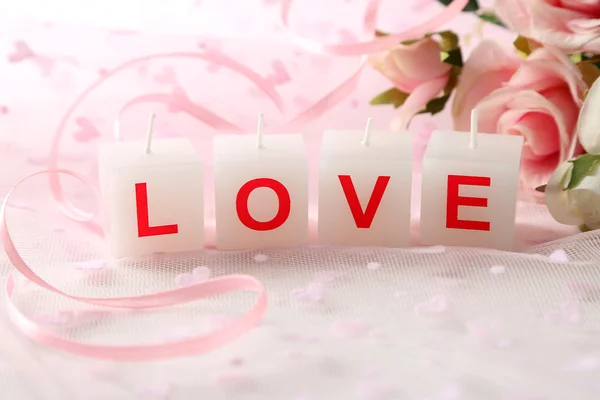 Candles with printed sign I LOVE YOU, on light background — стоковое фото