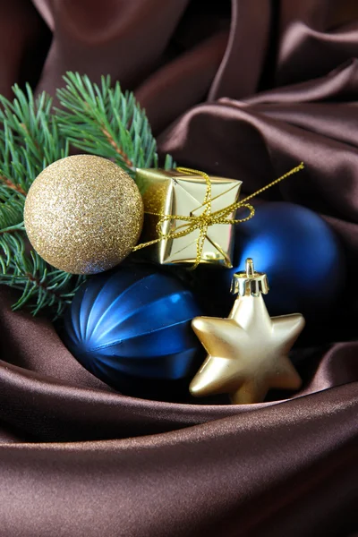 Beautiful Christmas decor on brown satin cloth — Stock Photo, Image