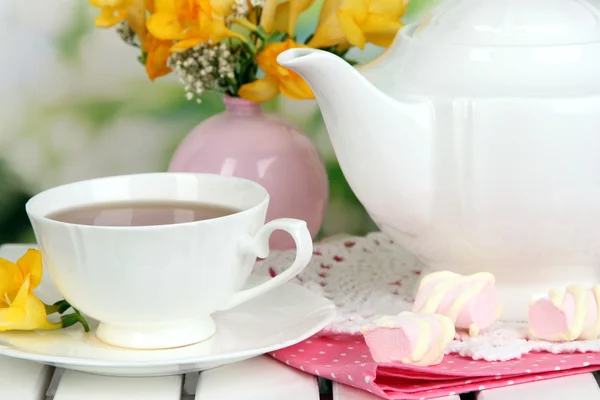 Conjunto bonito com chá na mesa de piquenique de madeira no fundo natural — Fotografia de Stock