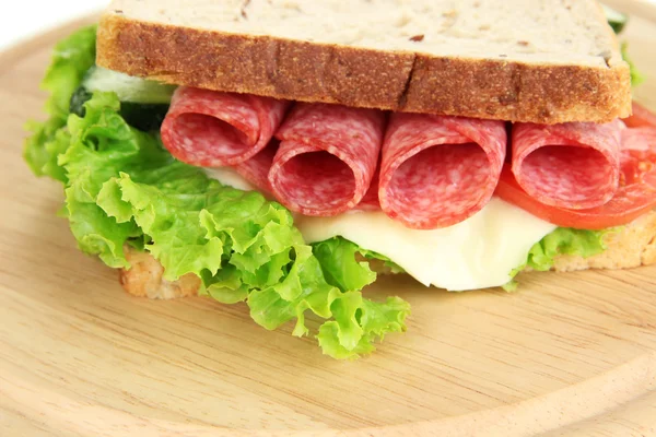 Tasty sandwich with salami sausage and vegetables on cutting board, close-up — Stock Photo, Image