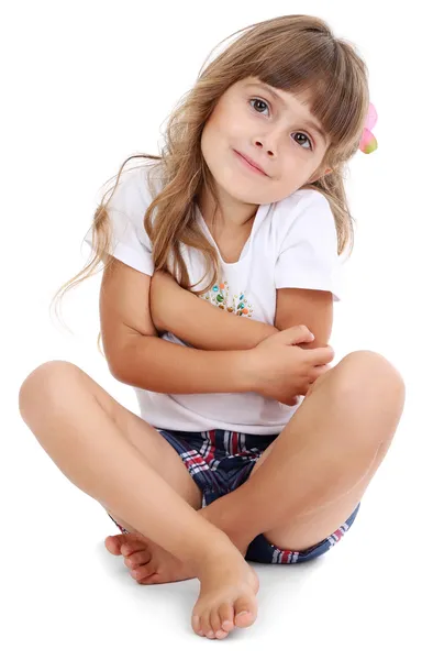 Küçük kız beyaz izole katta oturan — Stok fotoğraf
