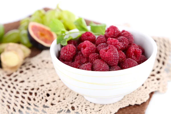 Raspberries in small bowl on napkin isolated on white — Stock Photo, Image
