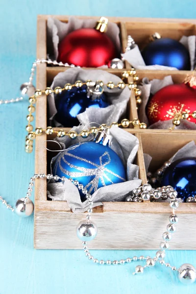 Christmas toys in box on wooden table close-up — Stock Photo, Image