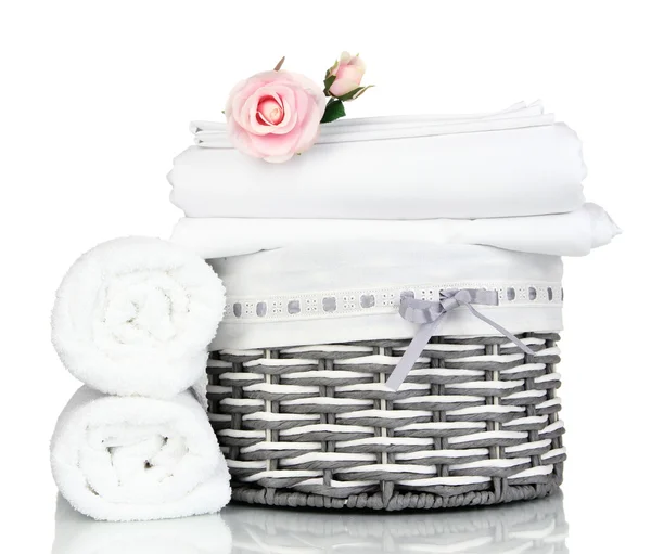 Bedding sheets in wicker basket isolated on white — Stock Photo, Image