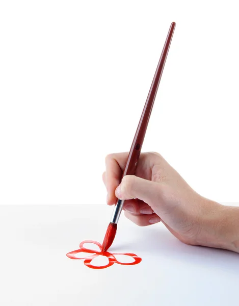 Hand holding brush with red paint isolated on white — Stock Photo, Image