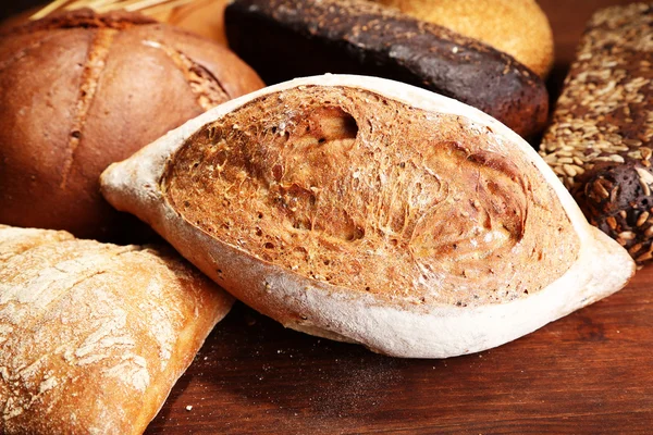 Much bread on wooden board — Stock Photo, Image