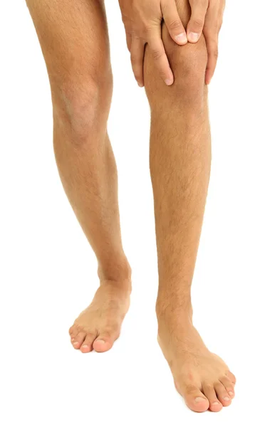 Молодой человек с болью в колене, изолированный на белом — стоковое фото