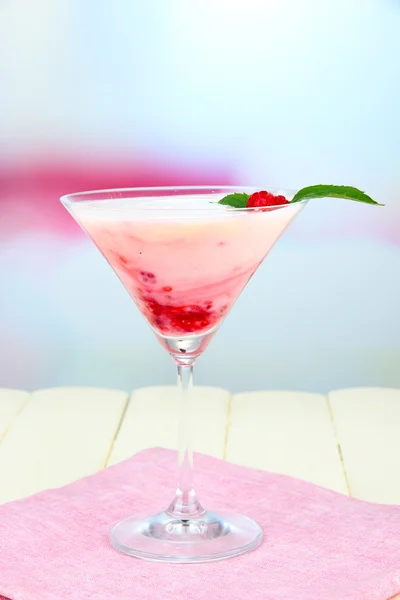 Raspberry milk dessert in cocktail glass, on light background — Stock Photo, Image