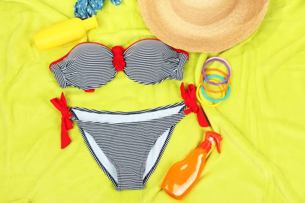 Swimsuit and beach items on bright background — Stock Photo, Image