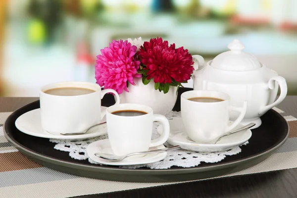 Cups of coffee on tray on table in cafe — Stock Photo, Image