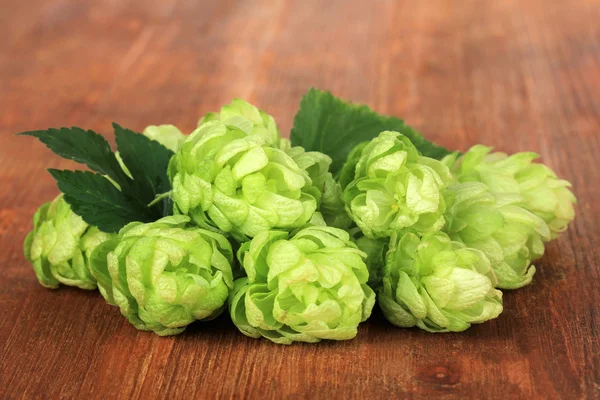 Fresh green hops, on wooden background — Stock Photo, Image