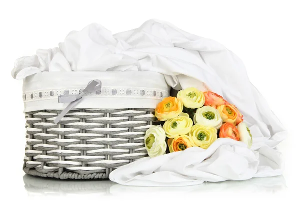 Rumpled bedding sheets in wicker basket isolated on white — Stock Photo, Image