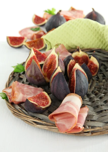 Tasty figs with ham on white wooden table — Stock Photo, Image