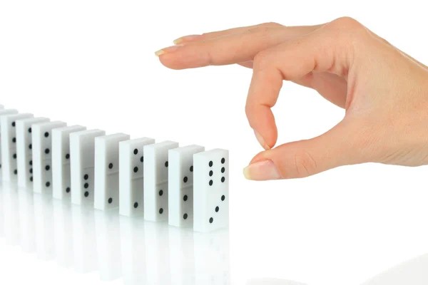 Hand pushing dominoes isolated on white — Stock Photo, Image