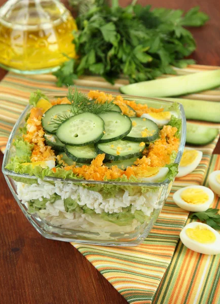 Delicious salad with eggs, cabbage and cucumbers on wooden table — Stock Photo, Image