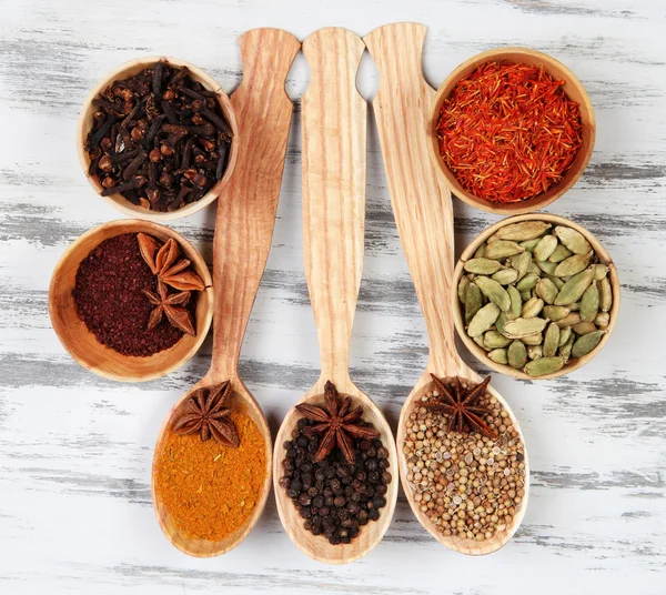 Various spices and herbs on wooden background — Stock Photo, Image