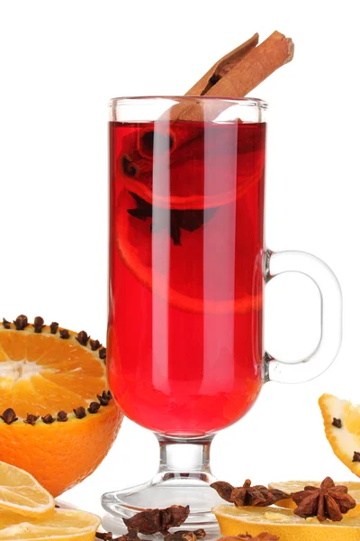Fragrant mulled wine in glass with spices and oranges around isolated on white — Stock Photo, Image