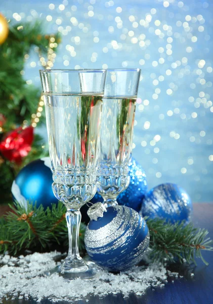 Composition with Christmas decorations and two champagne glasses, on bright background — Stock Photo, Image