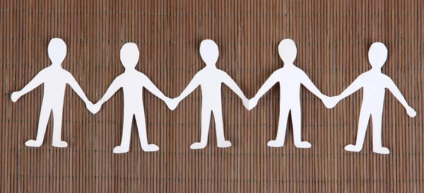 Paper people in social network concept on brown bamboo background — Stock Photo, Image