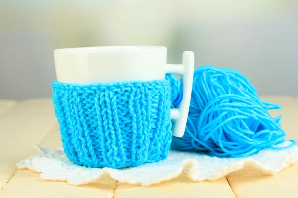 Cup with knitted thing on it close up — Stock Photo, Image