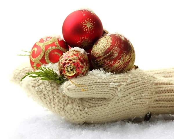 Female hands in mittens Christmas tree balls, on color background — Stock Photo, Image
