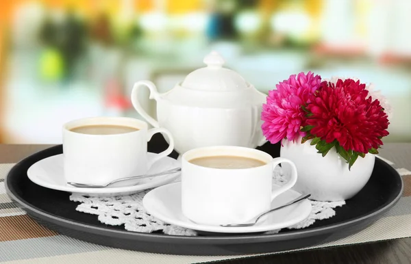 Cups of coffee on tray on table in cafe — Stock Photo, Image