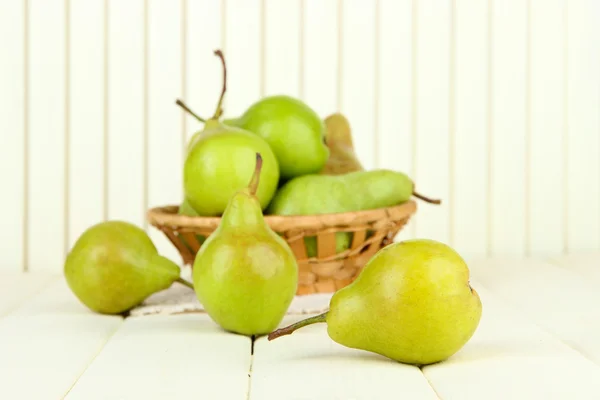 Pears in wicker basket, on light background — Stock Photo, Image