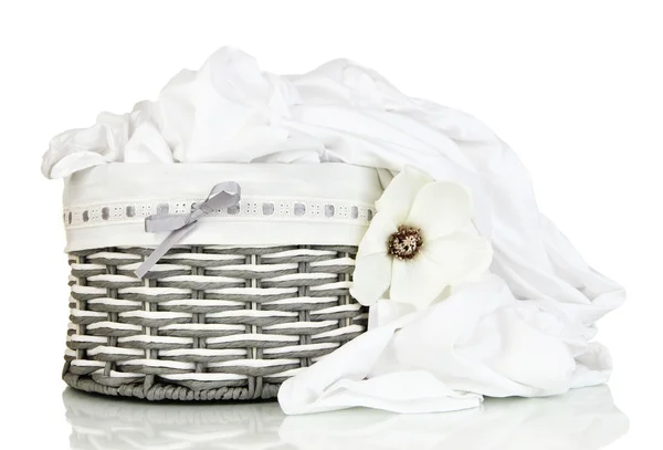 Rumpled bedding sheets in wicker basket isolated on white — Stock Photo, Image