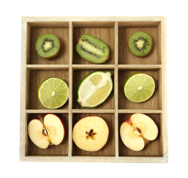 Sliced fruit in wooden box isolated on white — Stock Photo, Image
