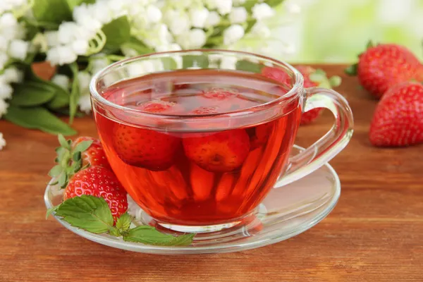 Delicious strawberry tea on table close-up — Stock Photo, Image