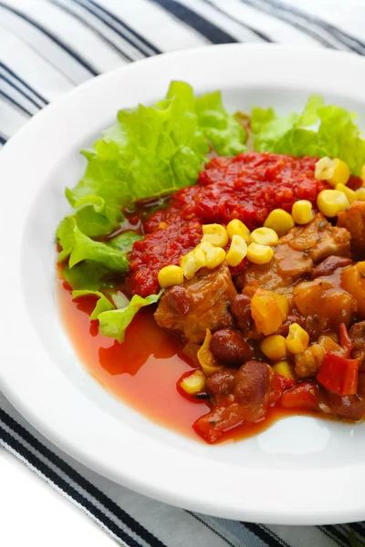 Chili Corn Carne - traditional mexican food, on white plate, on napkin, close up — Stock Photo, Image