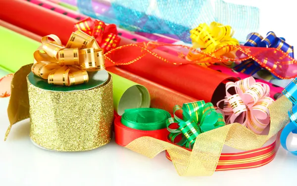 Rolls of Christmas wrapping paper with ribbons, bows isolated on white — Stock Photo, Image