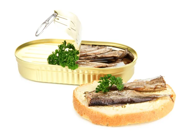 Open tin can with sardines and tasty sandwich, isolated on white — Stock Photo, Image