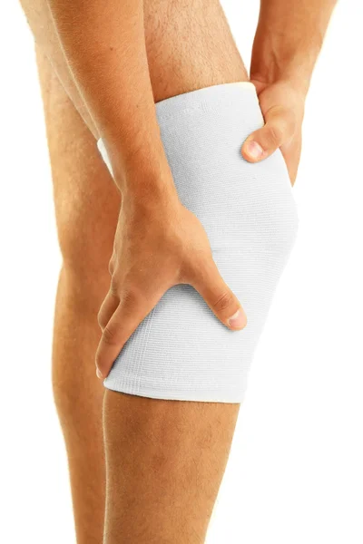 Young man with elastic bandage on knee, isolated on white — Stock Photo, Image