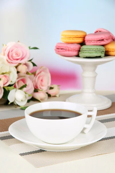 Coffee and macaroons on table on light background — Stock Photo, Image