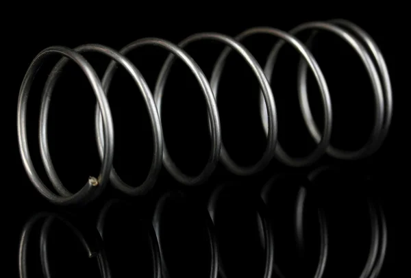 Coil spring on black background — Stock Photo, Image