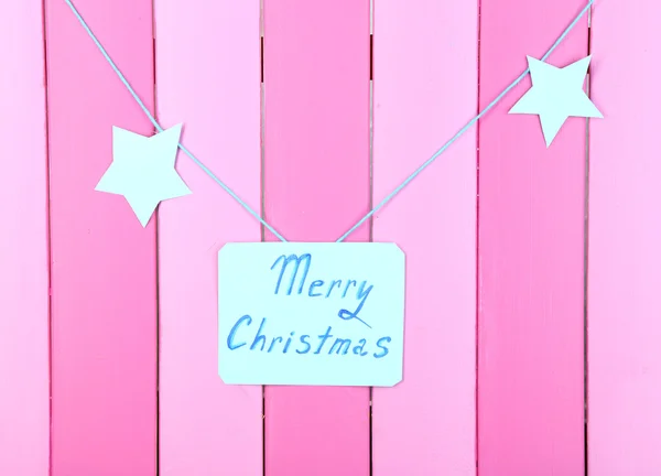 Signboard with words Merry Christmas on pink wooden table background close-up — Stock Photo, Image