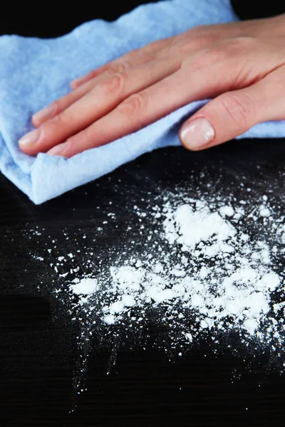 Hand wiping wooden surface with blue rag — Stock Photo, Image