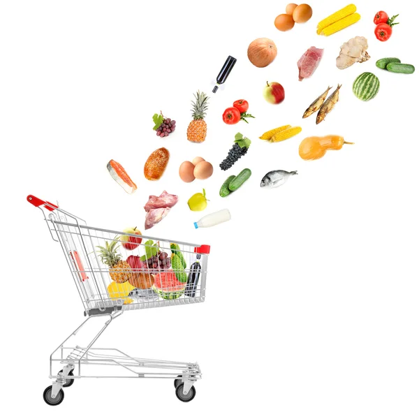 Food products flying out of shopping cart isolated on white — Stock Photo, Image