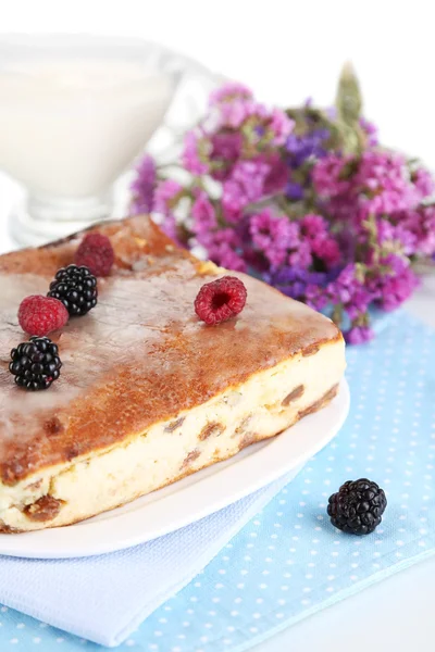 Cheese casserole with raisins on plate on napkin isolated on white — Stock Photo, Image