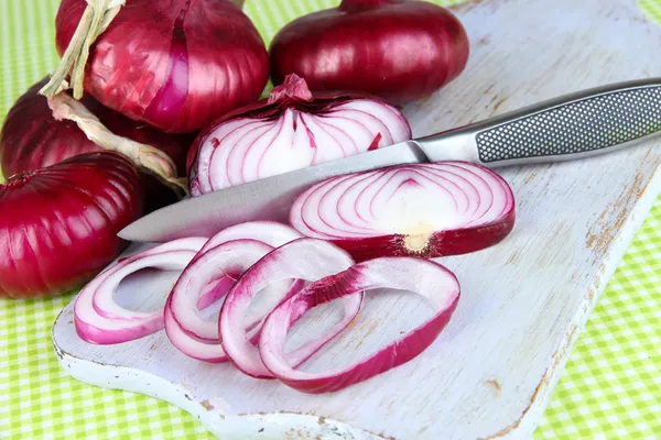 Frische rote Zwiebeln auf Schneidebrett aus nächster Nähe — Stockfoto