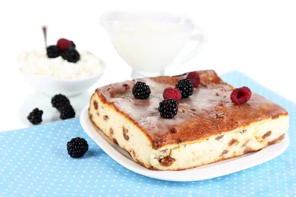 Cheese casserole with raisins on plate on napkin isolated on white — Stock Photo, Image